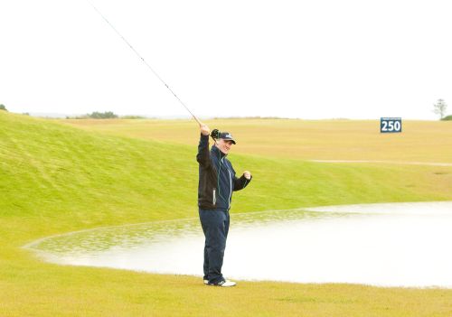 Stuart Adams fishing on the range at Castle Stuart - 2011 Scottish Open (red)