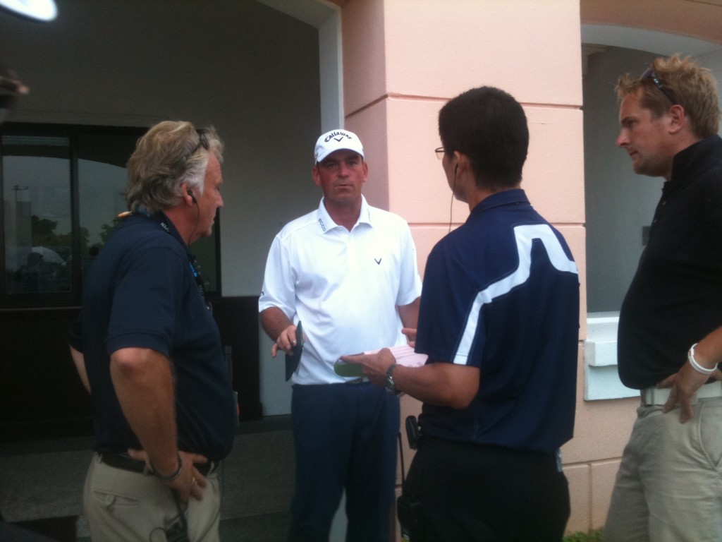 Thomas Bjorn in discussion with rules official Thomas Waldenstedt (L) after his round. Asian official (R)