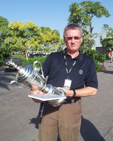 Mark Garrod inspects US Open trophy (red)