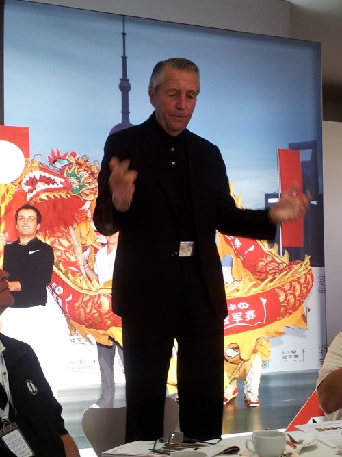 Gary Player stands on a chair (red)
