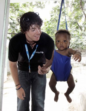 Rory McIlroy with Haitian baby in swing