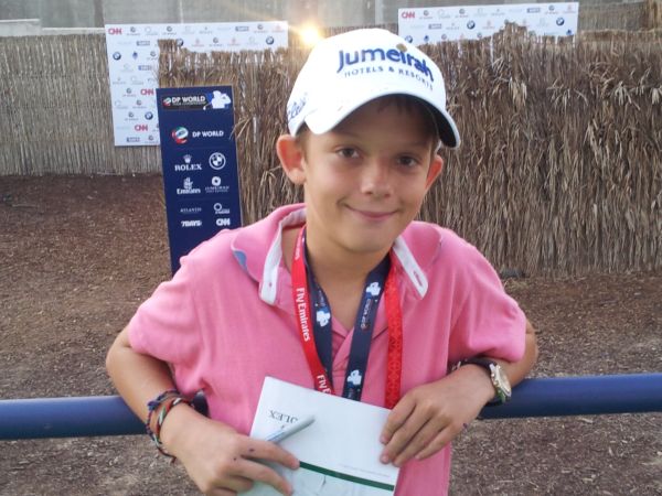 Charlie Fine proudly shows off McIlroys cap (red)