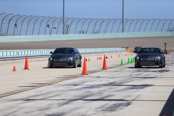 Matt Kuchar gets the jump on his wife during the Cadillac Challenge at Miami Speedway.  (Photo - Fran Caffrey/www.golffile.ie)