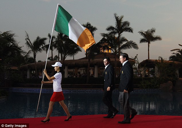 The Northern Ireland born pair of Rory McIlroy and Graeme McDowell walk in behind the Ireland flag at the 2011 World Cup of Golf at Hainan Island in China. (Photo - Getty Images)