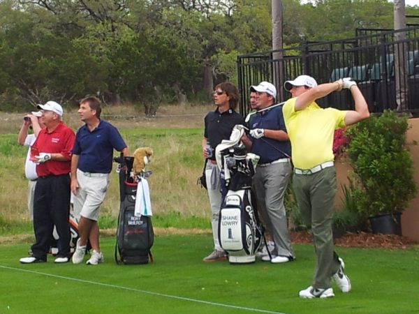 Rory McIlroy hitting off the 16th during a Tuesday practice round - Shane Lowry (Blue shirt) and his coach Neil Manchin (black shirt/sunglasses) along with Billy Mayfair (red shirt.) (Photo - www.golfbytourmiss.com)