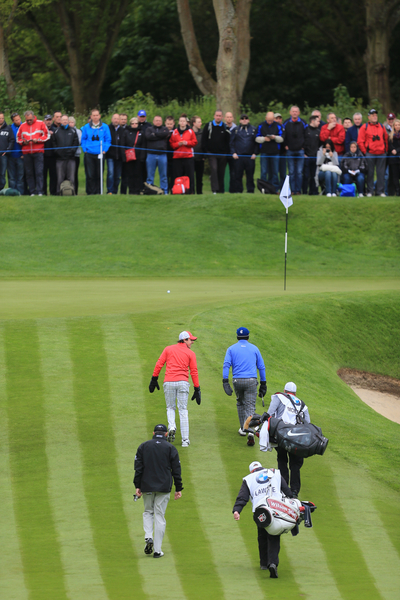 Rory McIlroy (red pullover) talking with Graeme McDowell as they walk onto the second green during the first round of the BMW PGA Championship at Wentworth. (Photo - Fran Caffrey/www.golffile.ie)