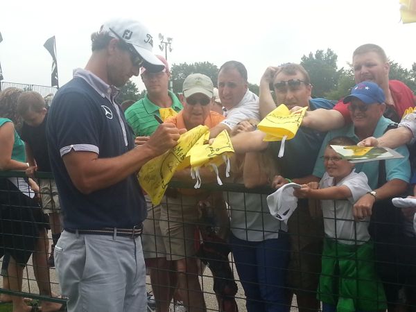 Adam Scott signing flags ahead of this week's WGC - Bridgestone Invitational. (Photo - www.golfbytourmiss.com)