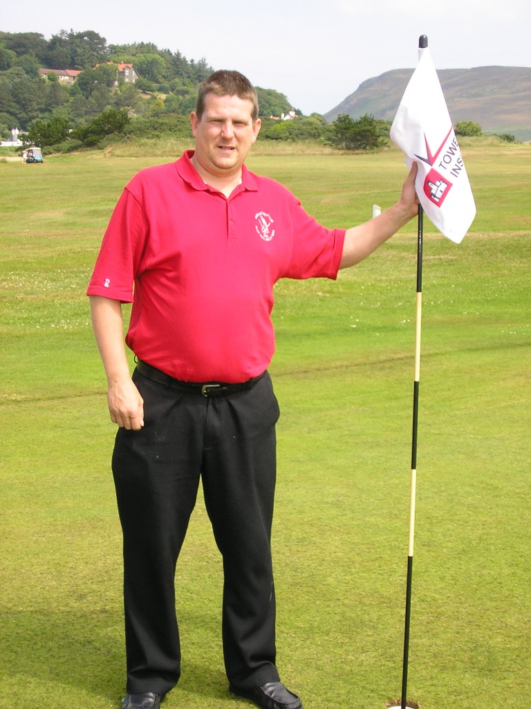Marc Morley poses beside the hole where he bagged a 300-yard ace.