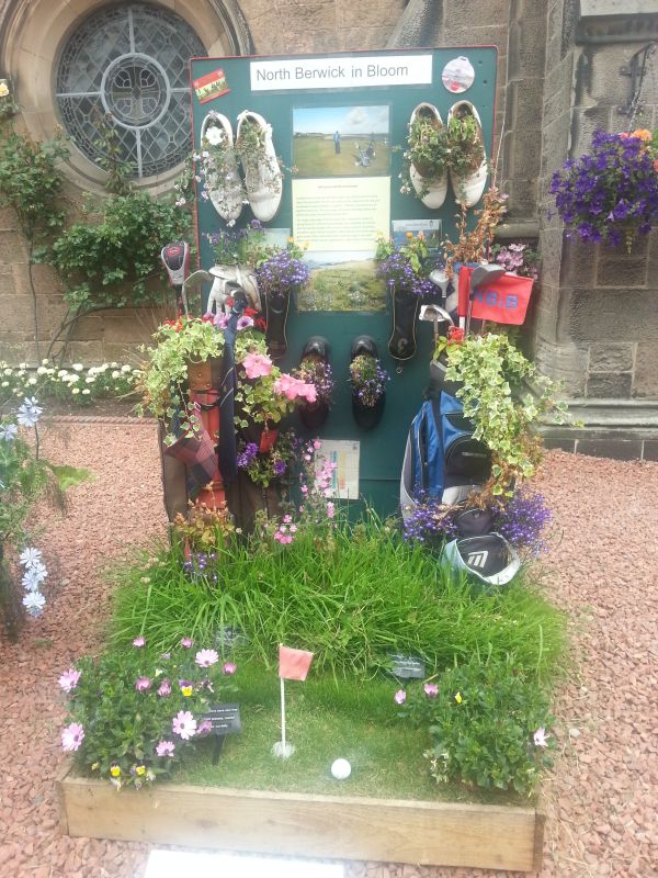 Some old golf shoes take centre stage in a North Berwick in bloom flower arrangement.  (Photo - www.golfbytourmiss.com)