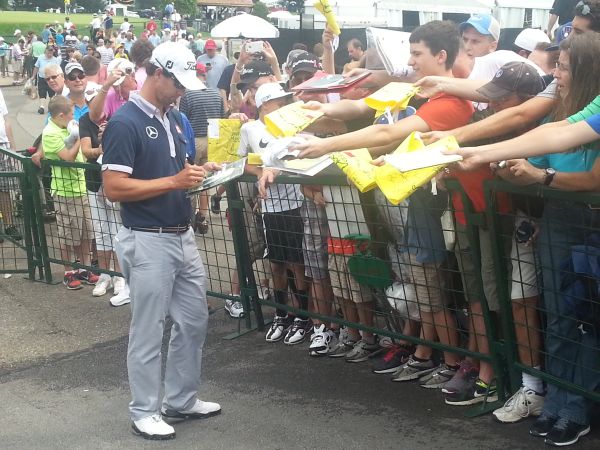 Adam Scott beseiged as he's asked to sign commemorative flags. (Photo - www.golfbytourmiss.com)