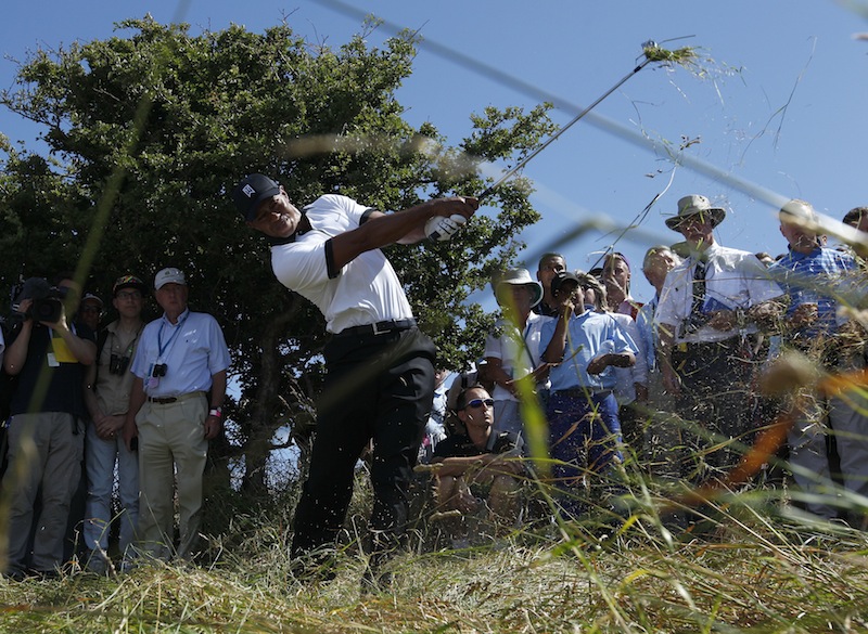 Tiger Woods blasts out of the rough at the very first hole in the 2013 Open. (Photo - www.golffile.ie)