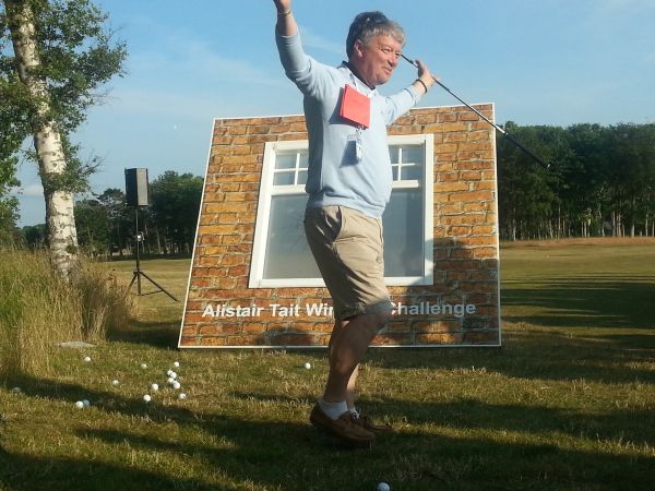 Thanks to Callaway's Sue Page, Alastair Tait gets to redeem himself in not breaking any windows at the Callaway 'Meet the Players' function at the Callaway 'Meet The Players' function during Open Championship week.