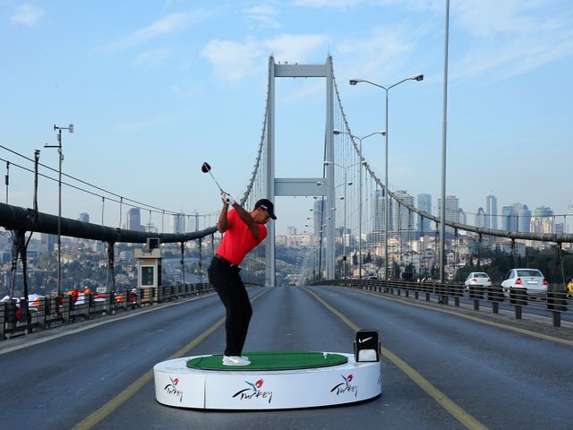 Tiger Woods hits golf balls from one continent to the next.