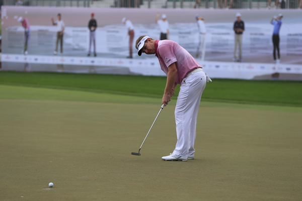 Stephen Gallacher (SCO) sinks his birdie putt on the 18th green during Saturday's Round 3 of the Omega Dubai Desert Classic 2014 held at the Emirates Golf Club, Dubai. 1st February 2014. Picture: Eoin Clarke www.golffile.ie