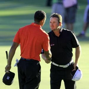 Graeme McDowell congratulates Tiger Woods after G Mac finished runner-up to Woods in 2012. (Photo - AP)