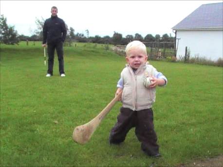 Two year old Sean Cooper and his father Feargal and the birthday gift of a hurling stick. (Photo - Elaine Stannard)