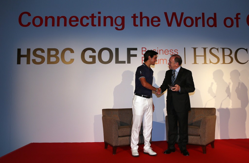 Matteo Manassero presents Peter Dawson, Chief Executive of The R&A with a special Lifetime Achievement Award during the 2014 HSBC Golf Business Forum at The Westin Hotel at Abu Dhabi Golf Club. (Photo by Warren Little/Getty Images).