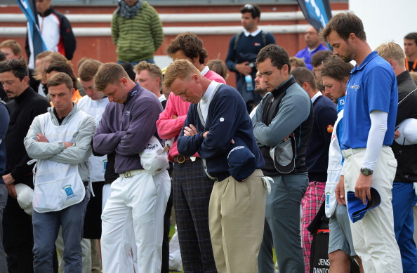 A minutes silence is held on the putting green for caddie Iain McGregor who tragically died on the 9th Fairway today, during the final round of the Madeira Islands Open - Portugal - BPI at Club de Golf do Santo da Serra on May 11, 2014 in Funchal, Madeira, Portugal. (Photo by Mark Runnacles/Getty Images)