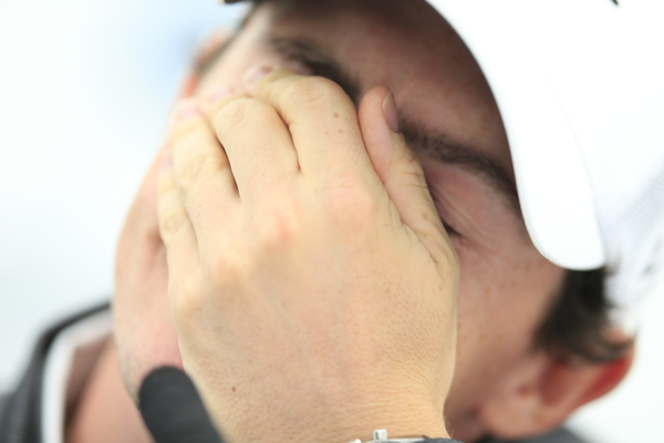 Rory McIlroy hides his face while answering questions about the break-up of his relationship with Caroline Wozniacki. (Photo - www.golffile.ie)