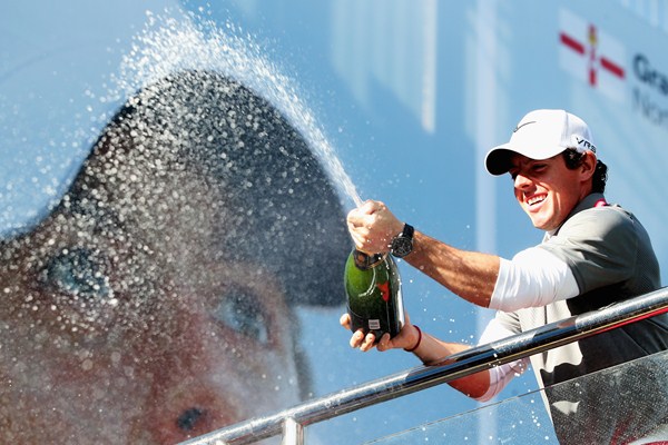 Rory McIlroy sprays champers over his fans while a picture of the new BMW PGA champion looks on. (Photo - www.europeantour.com)