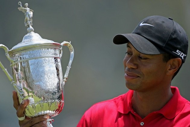Tiger Woods admires the U.S. Open trophy - his last Major success in 2008 at Torrey Pines.