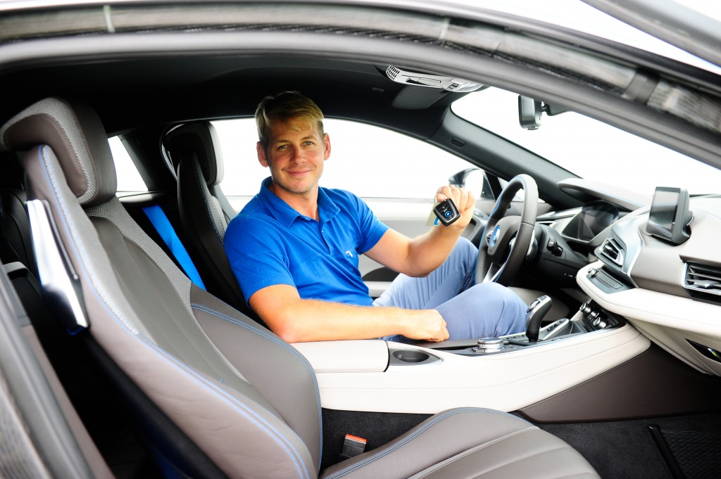James Heath behind the wheel of a BMW i8 and his prize for an ace at the  16th hole.