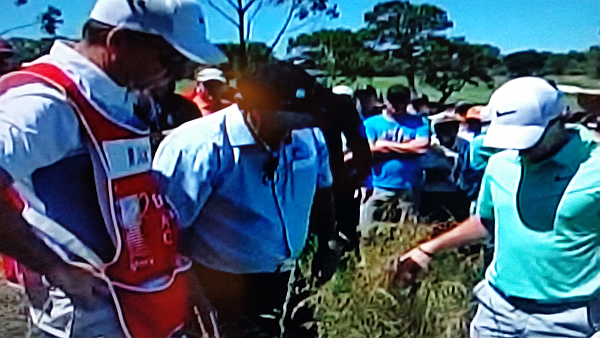 Rory again in discussion with a rules official at the 8th hole.