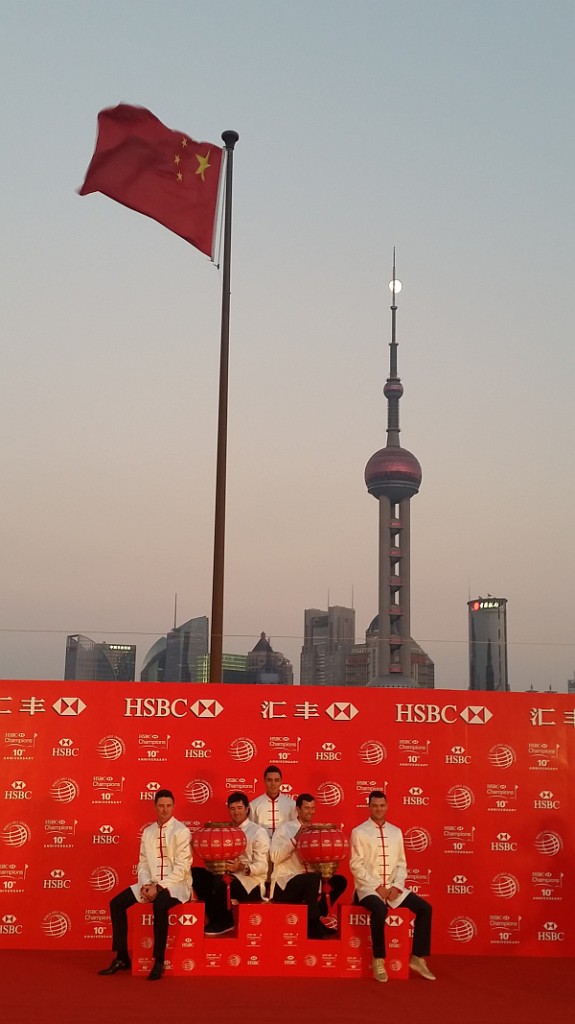 Some of the world's top golfers on stage as a full moon tries to hide behind the Oriental Pearl Tower.