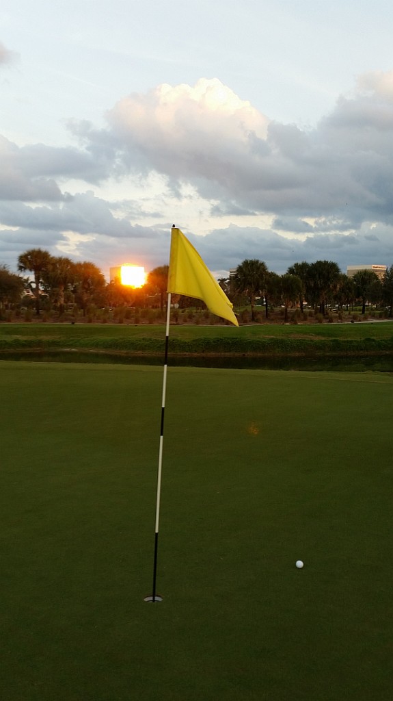 The settting sun reflecting off an apartment building lining the President Golf Club at West Palm Beach, Florida.  (Photo - www.golfbytourmiss.com)