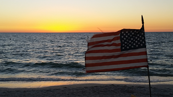 The Stars & Stripes as the sun sets over the Gulf of Mexico.