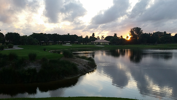 The setting sun lights up the sky at the par three, 11th hole. (Photo - www.golfbytourmiss.com)