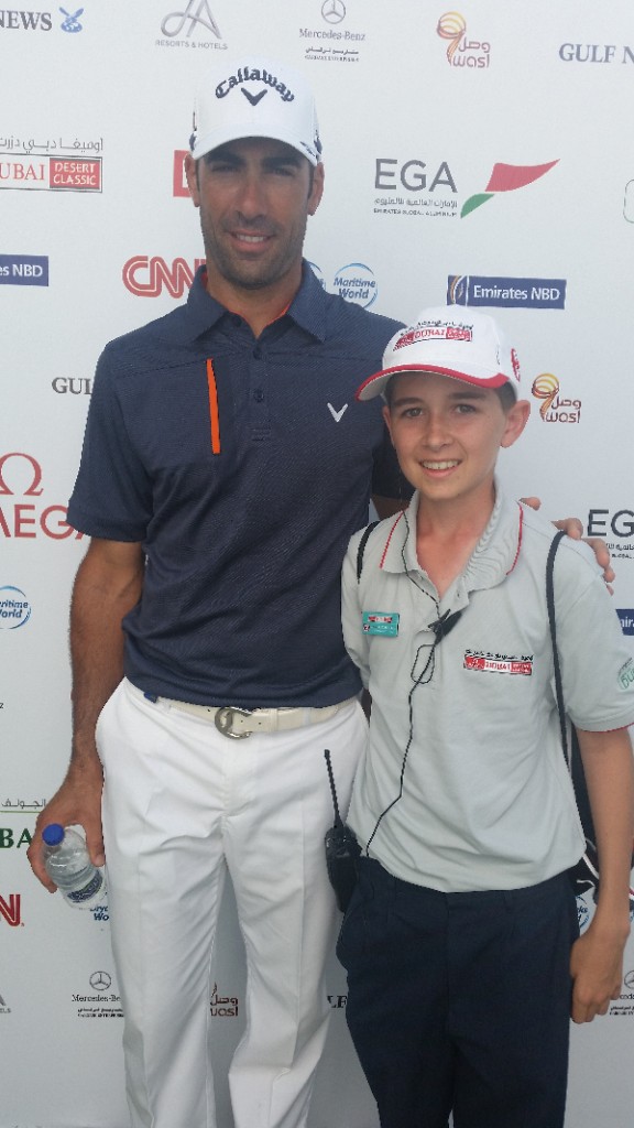 Alvaro Quiros with 13-year old Tom Roberts with the Manchester teenager acting as official scorer in Spaniard's final day group at the 2015 Omega Dubai Desert Classic.  (Photo - www.golfbytourmiss.com)