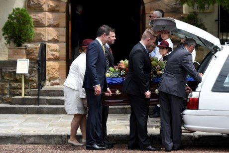 Kel Nagle's coffin being placed into car. (Photo - www.aap.com.au)
