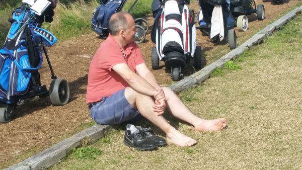 Bushnell/Odyssey front-runner Rodger Watson resting his 'dogs' before teeing off at Oitavos Dunes.