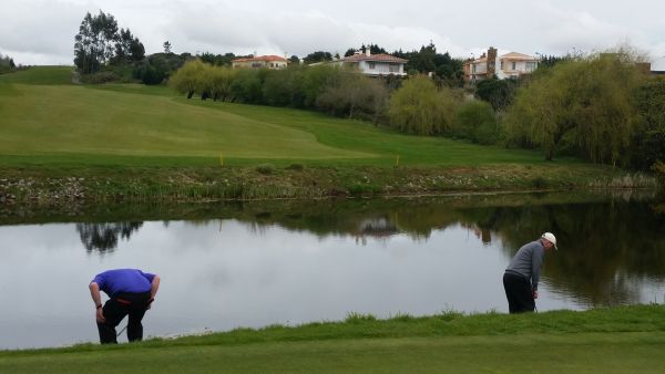Captain contest. What is Davy Patterson (left) and Eamon Scanlon doing with the backs turned to the green at the par five 6th hole?
