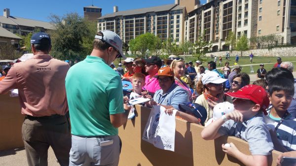 Martin Laird joins Matt Kuchar in signing autographs after their 3rd round.