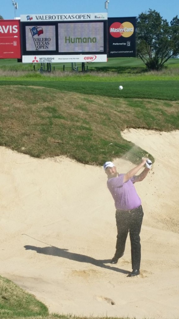 Shane Lowry blasts out of a bunker at the 15th hole on the TPC San Antonio course.  (Photo - www.golfbytourmiss.com)