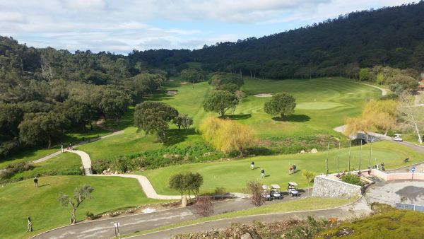 The boys warm-up for day three on the Penha Longa practice putting green with the 1st hole to the left and the 18th on the right.