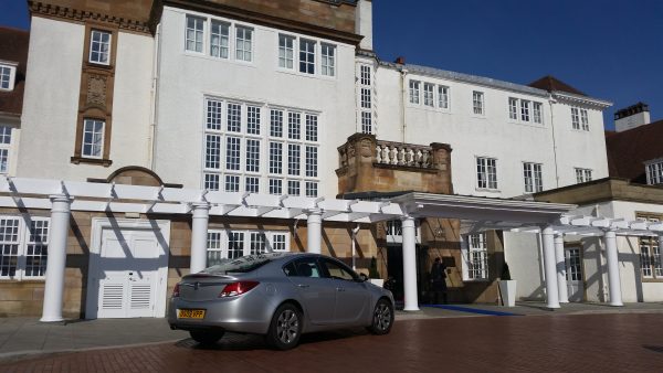 The car is parked in front of TrumpTurnberry.