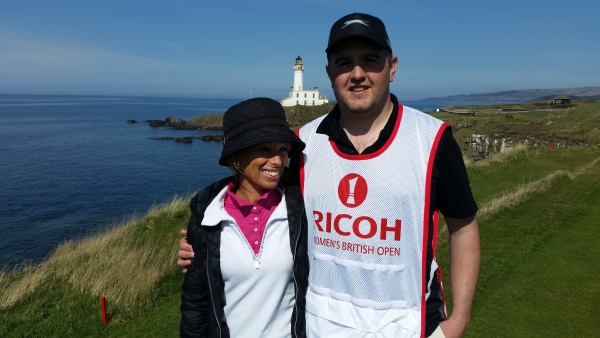 Tour Miss and caddy with the Turnberry Lighthouse in background.