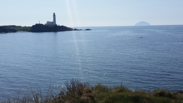Trump Turnberry lighthouse and Ailsa Craig in the background.