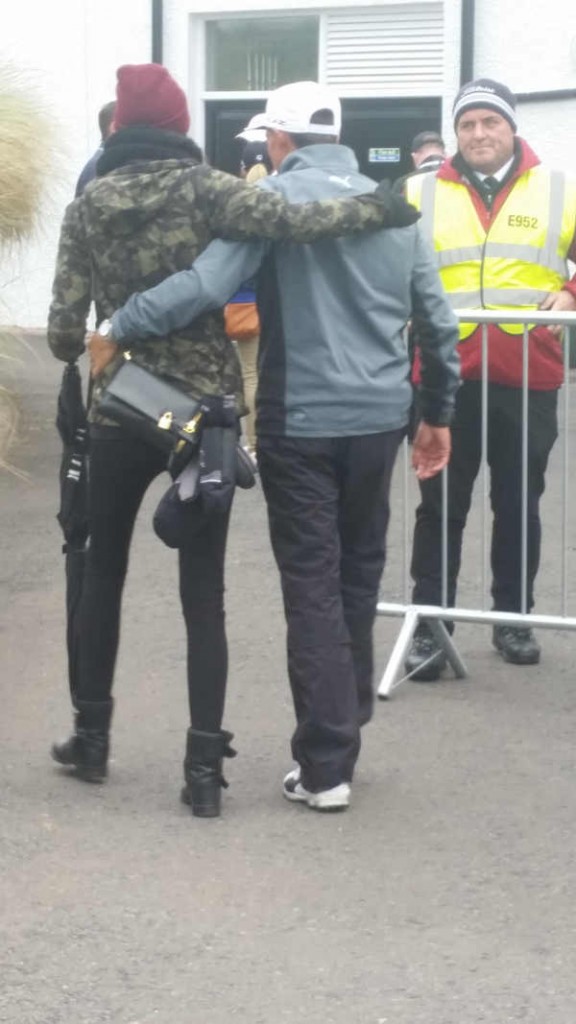 Rickie Fowler finds comfort in the arms of his girlfriend after finishing 2, 8, 8.