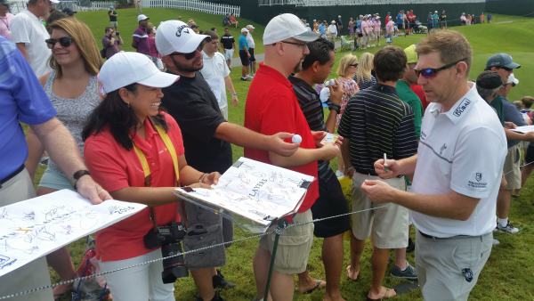 Stephen Gallacher about to delight one spectator with an autograph at the end of his final Players Championship practice round. (Photo - www.golffile.ie)