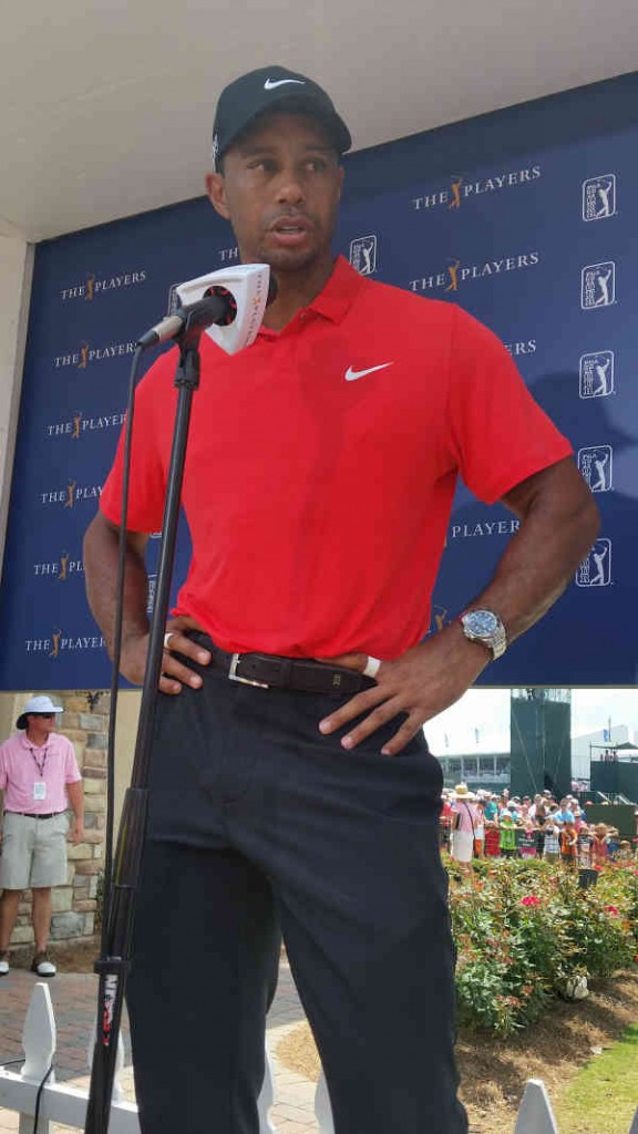 A perspiration dripping Tiger Woods soaks up some mediocre golf.