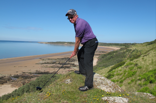 Bernie sets up to drive into the mill pond that is the Forth of Firth. (Photo - Stuart Adams/www.golffile.ie)