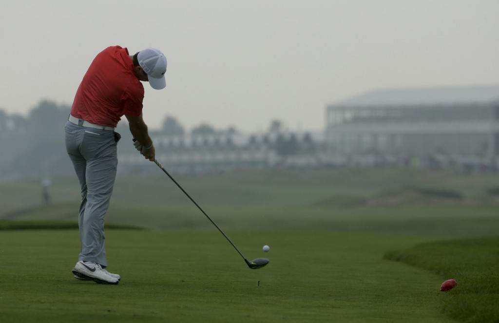Rory McIlroy drives off the 16th in the gloomy conditions today at Whistling Straits. (AP Photo/Chris Carlson)