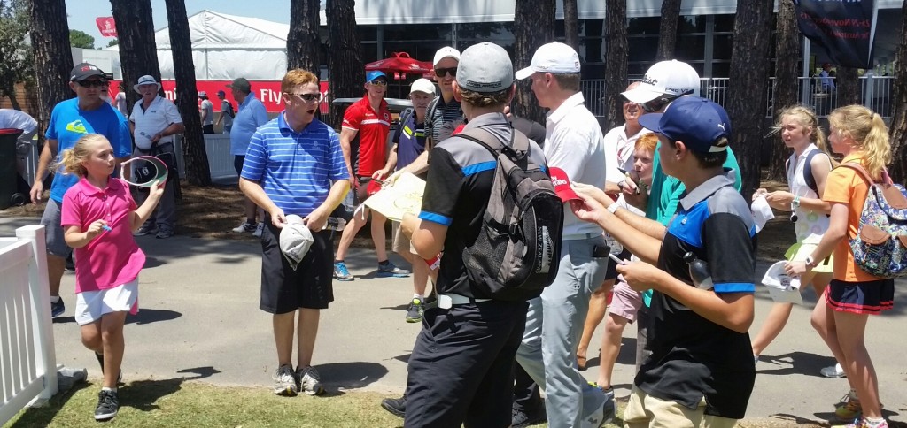 Double Major winning Jordan Speith mobbed as he heads to the scorer's hut.