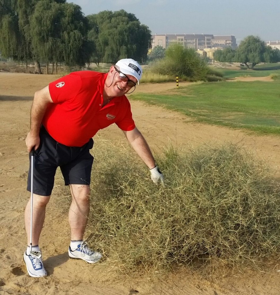 Stuart Adams points to his golf ball buried deep in a bush at the par 5, 13th hole.
