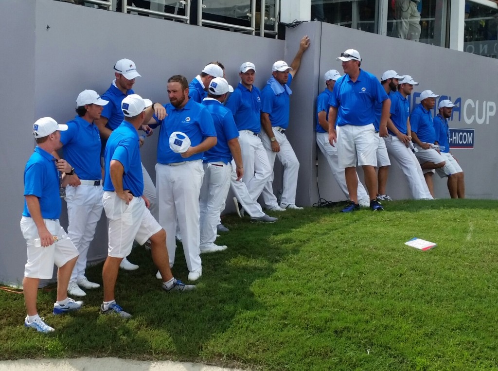 The European Team and caddies in the shade awaiting the outcome of the final match on day two of the EurAsia Cup