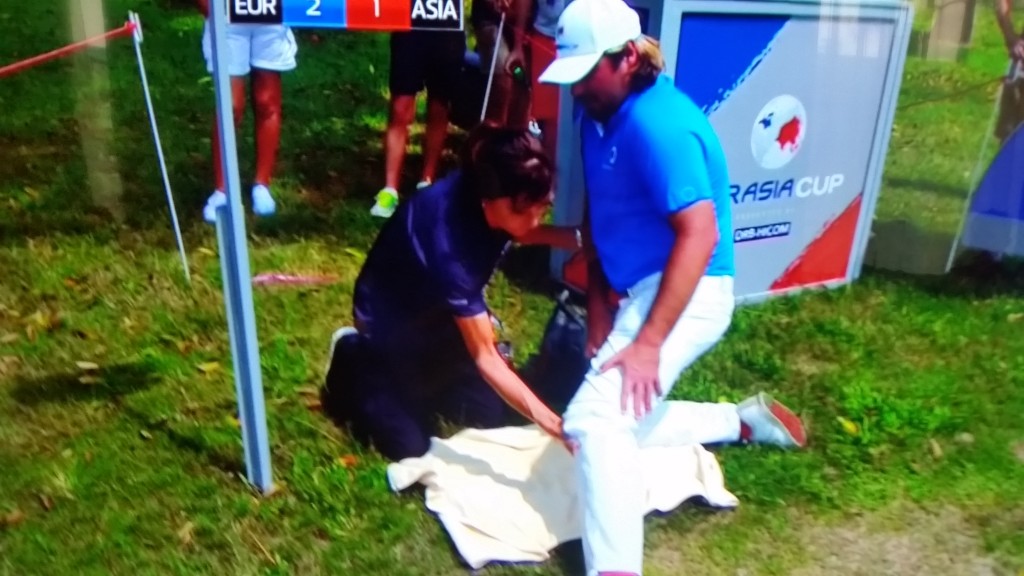 Victor Dubuisson receives treatment on the 16tyh tee for injured left knee.